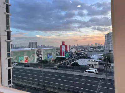 a view from a window of a city with a highway at La Casa Benice in Manila