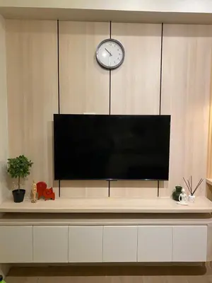 a large flat screen tv sitting on top of a cabinet at La Casa Benice in Manila