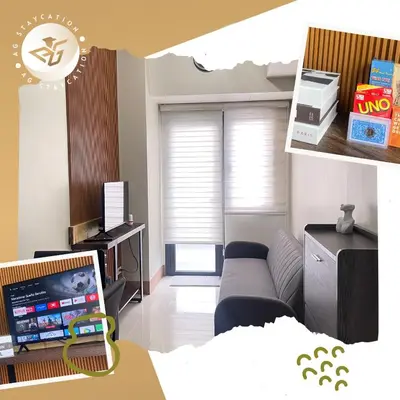 a living room with a couch and a tv at 1br with Balcony near MOA unit 2 in Manila