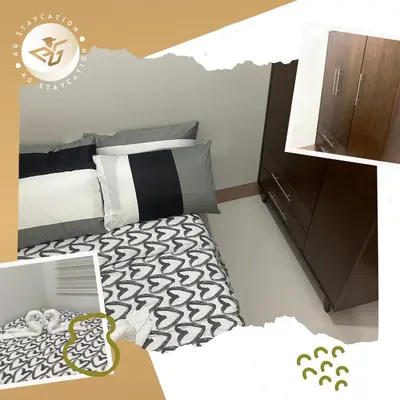 a bedroom with a black and white bed and a cabinet at 1br with Balcony near MOA unit 2 in Manila