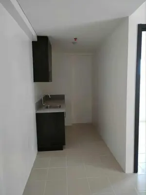 a kitchen with a sink and a counter in a room at The Roch in Manila