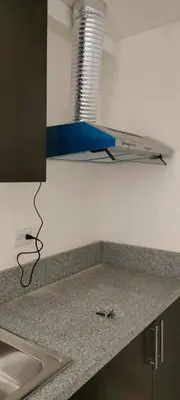 a kitchen counter top with a wire on the wall at The Roch in Manila