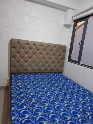 a large bed in a room with a window at Shore2 Residences in Manila