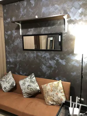 a living room with a couch and a mirror at Casa Reyes in Manila