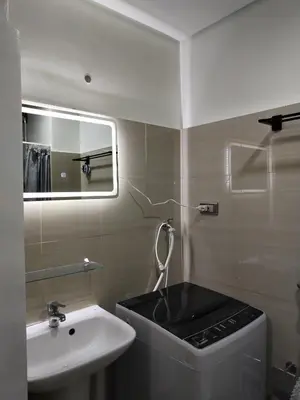 a bathroom with a sink and a toilet and a mirror at Casa Reyes in Manila