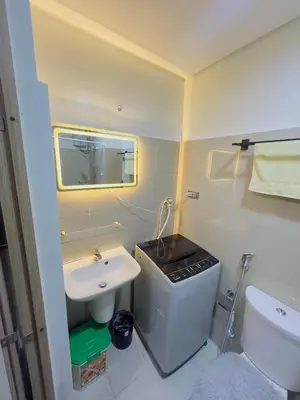 a small bathroom with a sink and a toilet at Casa Reyes in Manila