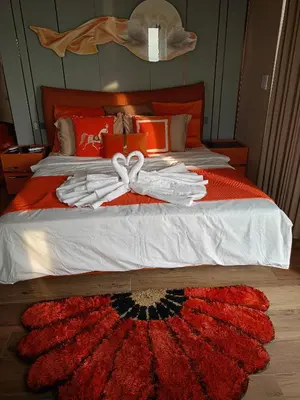 a bed with a red blanket with a bow on it at One Winstar Realty Corp in Manila