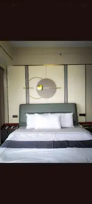 a bedroom with a large bed with white pillows at One Winstar Realty Corp in Manila