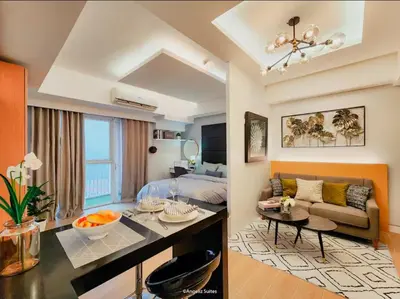 a living room with a bed and a couch in a room at One Bedroom Unit with Venice Canal View in Manila