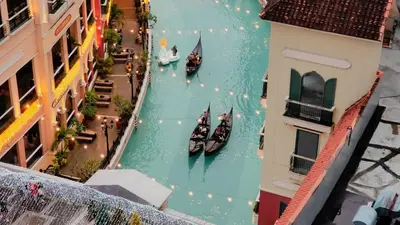 an aerial view of boats in a river with buildings at One Bedroom Unit with Venice Canal View in Manila
