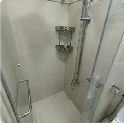 a bathroom with a shower with a glass door at Elegant Suite Near Mall of Asia & Naia Airport in Manila