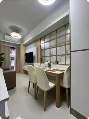 a kitchen and dining room with a table and chairs at Elegant Suite Near Mall of Asia & Naia Airport in Manila