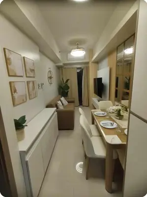 a small living room with a table and a couch at Elegant Suite Near Mall of Asia & Naia Airport in Manila