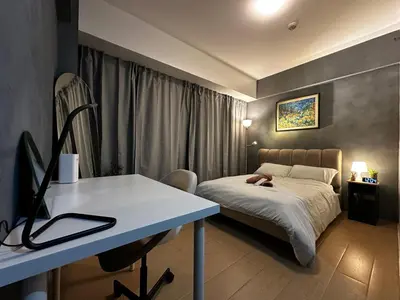 a bedroom with a bed and a desk with a computer at 1BR Stay near NAIA Terminal 3 via Runway Manila in Manila