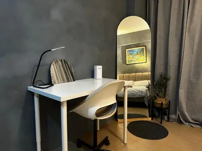 a desk and chair in a room with a mirror at 1BR Stay near NAIA Terminal 3 via Runway Manila in Manila