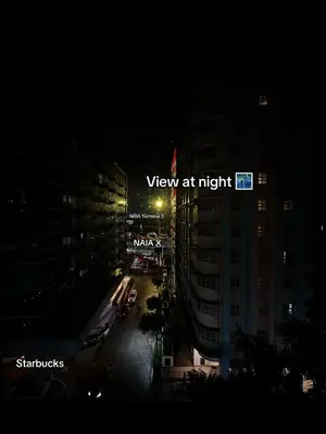 a view of a city at night with a street sign at 1BR Stay near NAIA Terminal 3 via Runway Manila in Manila