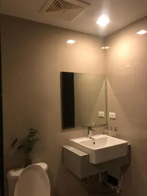 a bathroom with a sink and a toilet and a mirror at Bayshore 2 Residential Resort Phase 1 in Manila