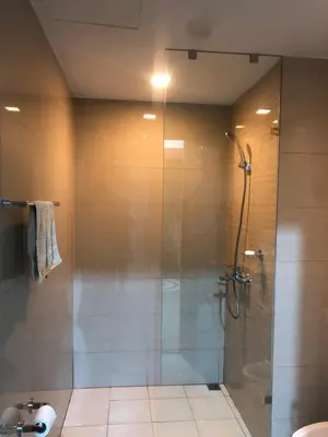 a bathroom with a shower with a glass door at Bayshore 2 Residential Resort Phase 1 in Manila