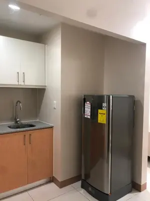 a kitchen with a stainless steel refrigerator and a sink at Bayshore 2 Residential Resort Phase 1 in Manila