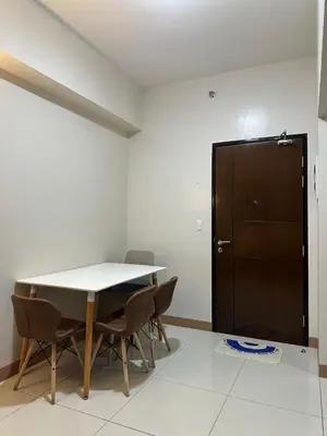 a dining room with a table and chairs and a door at Bayshore 2 Residential Resort Phase 1 in Manila