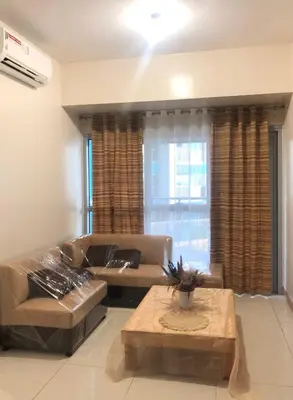 a living room with a couch and a table at Bayshore 2 Residential Resort Phase 1 in Manila