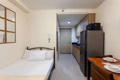 a small room with a bed and a kitchen at Shore Residences Family Suite near MOA 1 Bedroom with Balcony - 3beds good for 6 person in Manila