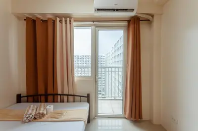 a bedroom with a bed and a large window at Shore Residences Family Suite near MOA 1 Bedroom with Balcony - 3beds good for 6 person in Manila