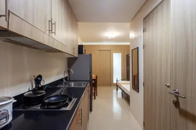 a kitchen with a sink and a counter top at Shore Residences Family Suite near MOA 1 Bedroom with Balcony - 3beds good for 6 person in Manila