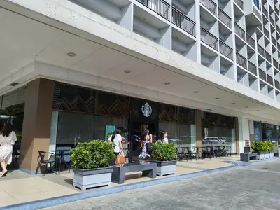 a group of people walking outside of a building at Shore Residences Family Suite near MOA 1 Bedroom with Balcony - 3beds good for 6 person in Manila
