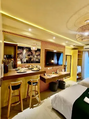 a hotel room with a bar and a bed at Crib2Go Lupita Suite with City Street View in Manila