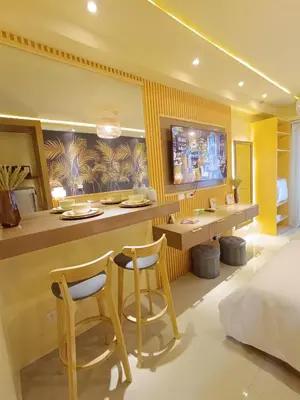 a hotel room with a bar and two chairs at Crib2Go Lupita Suite with City Street View in Manila