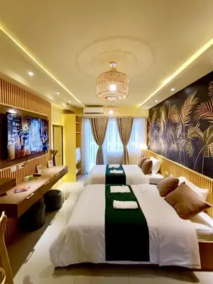a hotel room with two beds and a television at Crib2Go Lupita Suite with City Street View in Manila