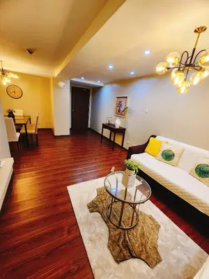a living room with a couch and a table at Furnished 2Bedroom 2Bathroom plus Utility Room with 2 Beds in Manila