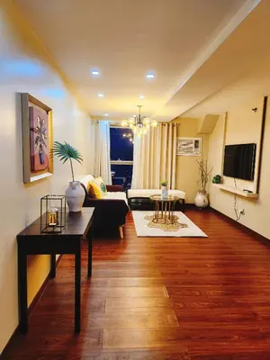a living room with a couch and a table at Furnished 2Bedroom 2Bathroom plus Utility Room with 2 Beds in Manila