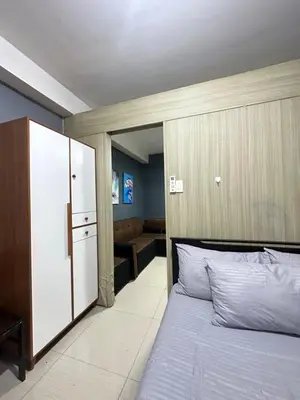 a bedroom with a bed and a couch in it at shore 880 staycation in Manila