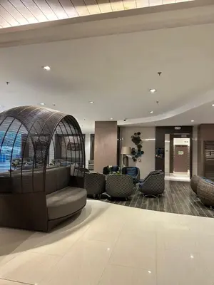 a lobby with a bird cage in the middle at shore 880 staycation in Manila