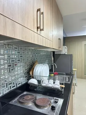 a kitchen with a dish rack on the counter at shore 880 staycation in Manila
