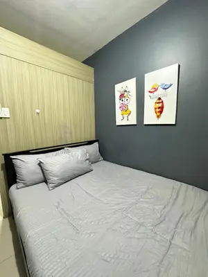 a bedroom with a bed with three pictures on the wall at shore 880 staycation in Manila