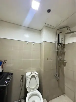 a bathroom with a toilet and a shower at shore 880 staycation in Manila