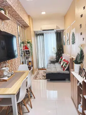 a living room with a table and a couch at El Romantico Staycation at Fame Residence in Manila