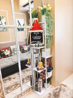 a shelf with a sign in a room at El Romantico Staycation at Fame Residence in Manila