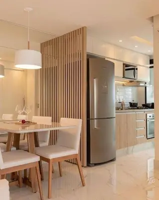 a kitchen with a table and a stainless steel refrigerator at Smith's Apartment in Taytay