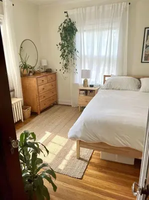 a bedroom with a bed and a dresser and a mirror at Smith's Apartment in Taytay