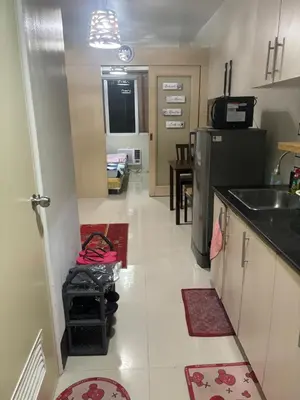 a kitchen with a sink and a refrigerator at Joie Selene in Manila