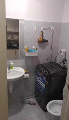 a small bathroom with a toilet and a sink at Joie Selene in Manila
