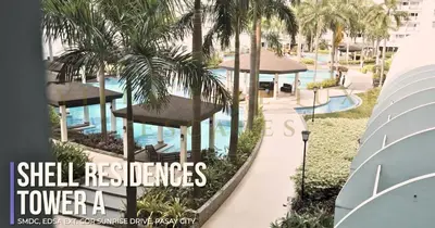 a magazine cover of a resort with a pool and palm trees at 1 Bed Room Shell Residence at Heart of Metro Manila - Pasay City in Manila