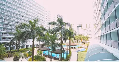 arial view of a resort with palm trees and a building at 1 Bed Room Shell Residence at Heart of Metro Manila - Pasay City in Manila