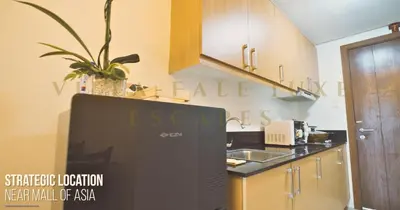 a kitchen with a refrigerator and a sink at 1 Bed Room Shell Residence at Heart of Metro Manila - Pasay City in Manila