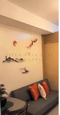 a living room with a black couch with orange pillows at 1 Bed Room Shell Residence at Heart of Metro Manila - Pasay City in Manila