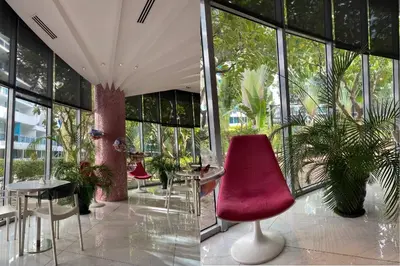 a room with chairs and tables and windows at Azure Urban Resort by Melrose Avenue in Manila